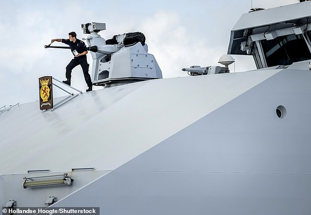 Crew members prepared the Navy ship Zr.Ms. Holland ahead of the royal family's departure from Aruba