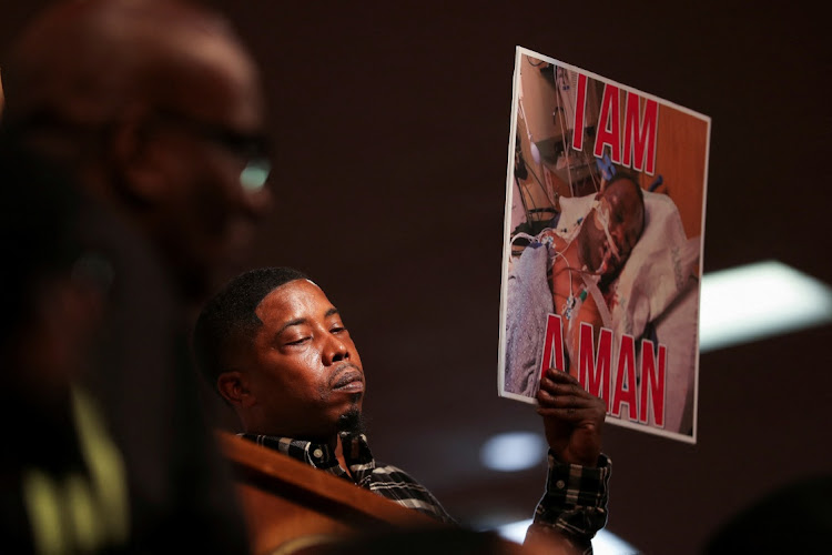 A person holds a placard with a picture of Tyre Nichols during a news conference held by the family members of Nichols, the Black man who was beaten by Memphis police officers during a traffic stop and died three days later, at Mason Temple: Church of God in Christ World Headquarters, in Memphis, Tennessee, US, January 31, 2023.