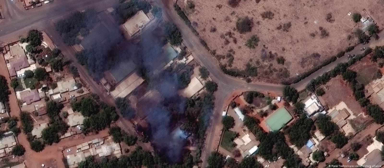 This satellite image provided by Maxar Technologies shows burning buildings and military patrol northeast of Khartoum International Airport
