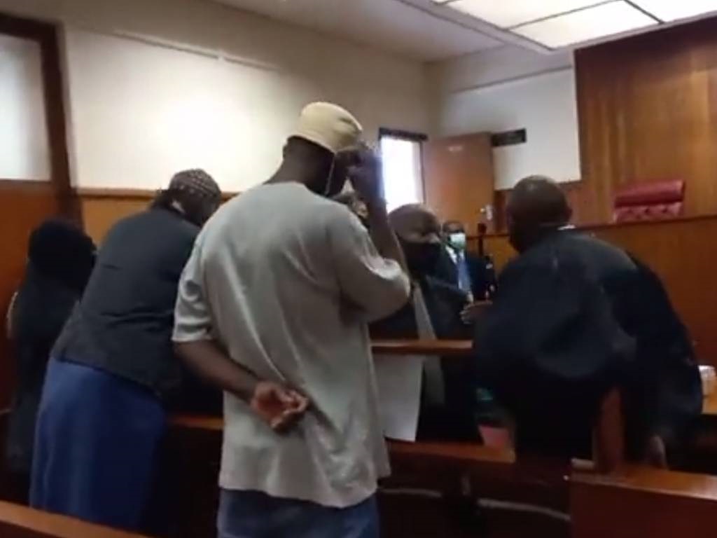 Aslam del Vecchio, Fatima Patel and Ahmed Jackson consult with their attorney in the KwaZulu-Natal High Court.