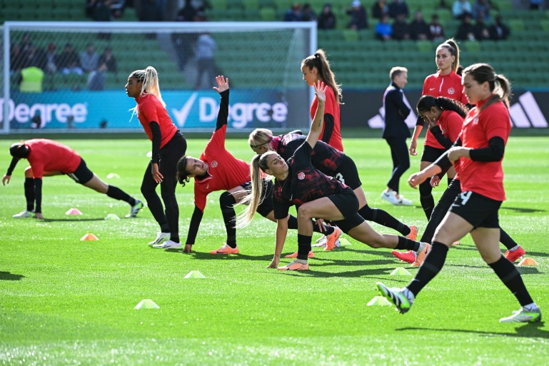 Canada players warm up prior to the start of the Australia and New Zealand 2023 Women's World Cup Group B football match between Nigeria and Canada at Melbourne Rectangular Stadium, also known as AAMI Park, in Melbourne on July 21, 2023. (Photo by WILLIAM WEST / AFP)
