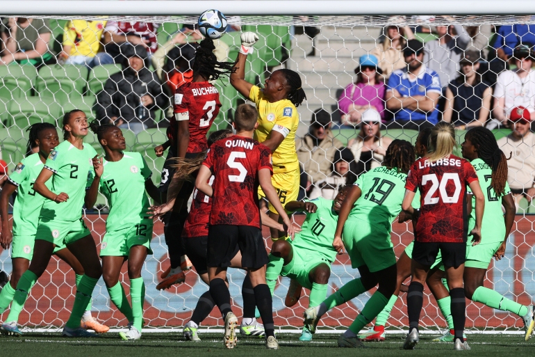 Nigeria's goalkeeper Chiamaka Nnadozie punches the ball clear of Canada's Kadeisha Buchanan during the Women's World Cup Group B soccer match between Nigeria and Canada in Melbourne, Australia, Friday, July 21, 2023. (AP Photo/Hamish Blair)