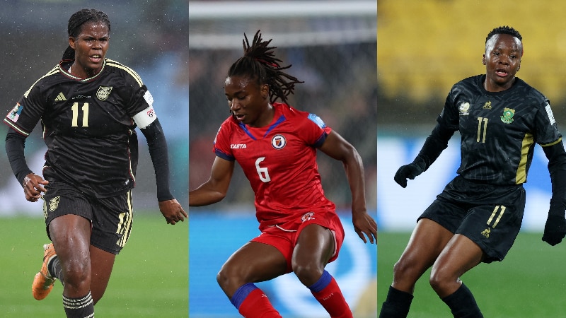 Three black women footballers wearing national team uniforms during a major tournament
