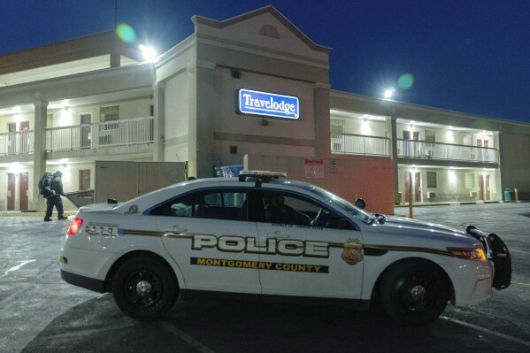 A Montgomery County, Md., police car sits in the parking lot at Travelodge hotel in Silver Spring, Md., Monday, Feb. 26, 2024. Aaron Bushnell of San Antonio, an active-duty member of the U.S. Air Force has died after he set himself ablaze outside the Israeli Embassy in Washington. Investigators believe Bushnell had been staying at a Travelodge in Silver Spring, Maryland, which was searched Monday by federal agents, a law enforcement official said. (AP Photo/Jose Luis Magana)