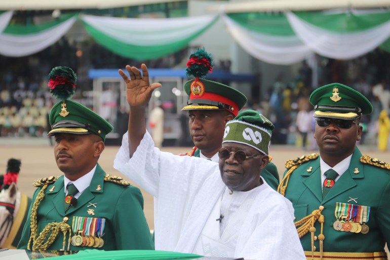 Nigeria National Anthem FILE - Nigeria's new President Bola Ahmed Tinubu, inspects honor guards after taking an oath of office at a ceremony in Abuja, Nigeria, on May 29, 2023. Nigeria adopted a new national anthem on Wednesday, May 29, 2024, after lawmakers passed a law that replaced the current one with a version dropped nearly 50 years ago, sparking widespread criticism about how the law was hastily passed without much public input.(AP Photo/Olamikan Gbemiga, File)