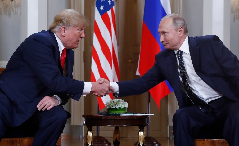 US President Donald Trump, left, and Russian President Vladimir Putin, right, shake hands at the beginning of a meeting at the Presidential Palace in Helsinki, Finland, July 16, 2018.