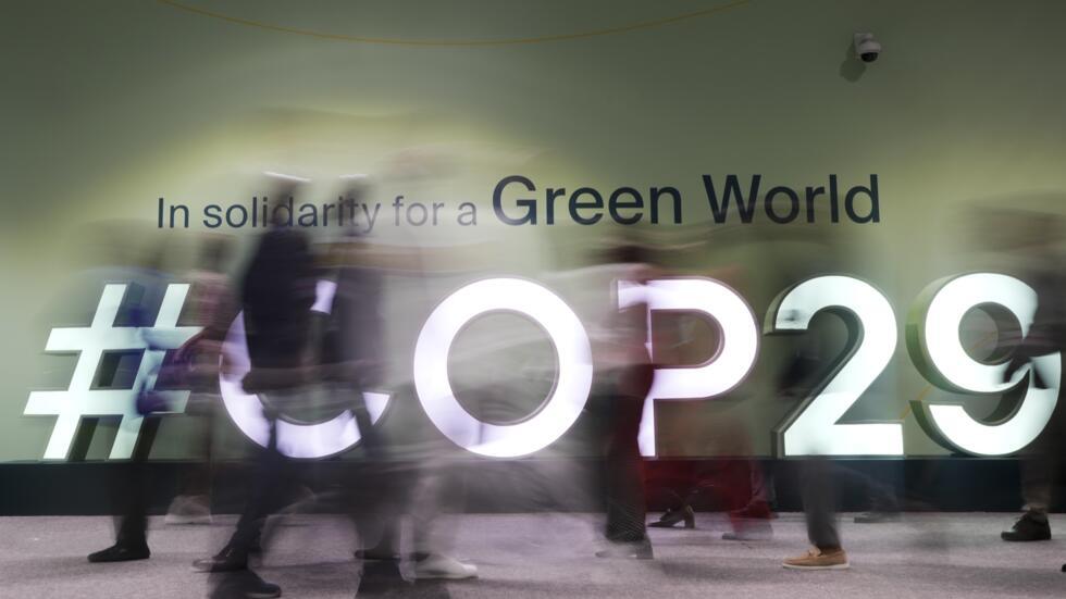People walk through the Cop29 UN Climate Summit, Wednesday, 13 November, 2024, in Baku, Azerbaijan. 