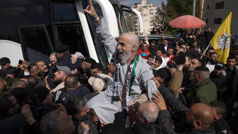 Palestinian prisoners as greeted as they exit a Red Cross bus after being released from Israeli prison following a ceasefire agreement between Israel and Hamas, in the West Bank city of Ramallah, Saturday Feb. 1, 2025. (AP Photo/Mahmoud Illean)
