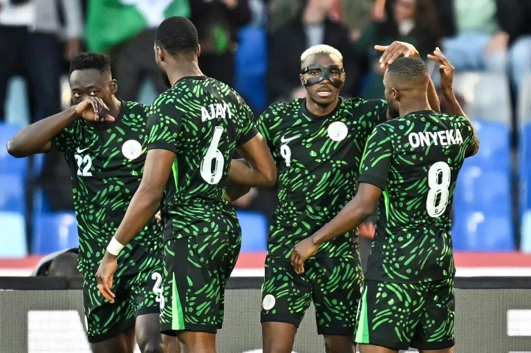 Victor Osimhen, wearing his trademark mask, celebrates after scoring Nigeria's opening goal against Algeria (Paul ELLIS)