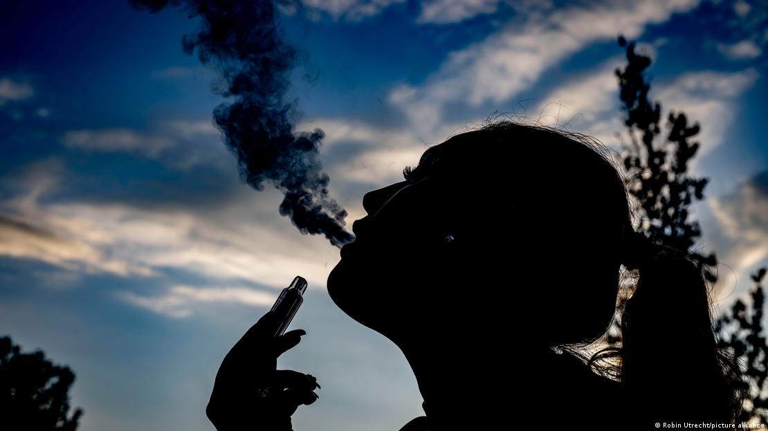 The silhouette of a young woman vaping, in an image taken in Rotterdam on May 23, 2024. 